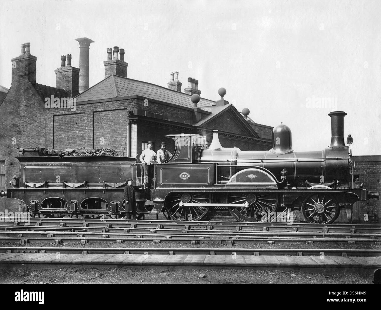 North Staffordshire Railway steam Locomotive No 14 and its tender.  This 2-4-0 locomotive, pictured with driver and fireman on the footplate, was built by Dubs & Co. of Glasgow and delivered in 1875. Photograph. Stock Photo