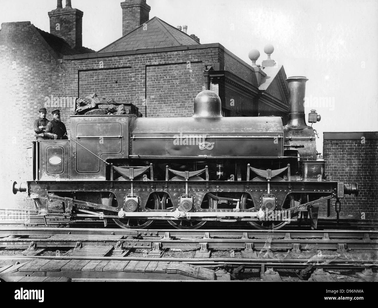 North Staffordshire 0-6-0 steam locomotive with driver and fireman on the footplate. 19th century. Photograph. Stock Photo