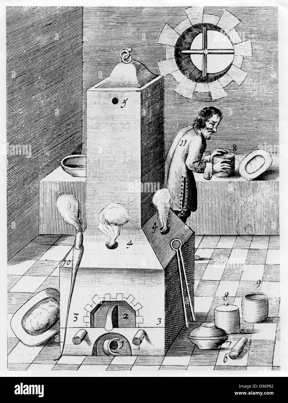 Furnace for processes where protracted heat required, such as cementation. This furnace is gravity-fed and self-stoking. From 1683 English edition of 'Beschreibung allerfurnemisten mineralischen Ertzt', Lazarus Ercker, (Prague, 1574). Copperplate engraving. Stock Photo