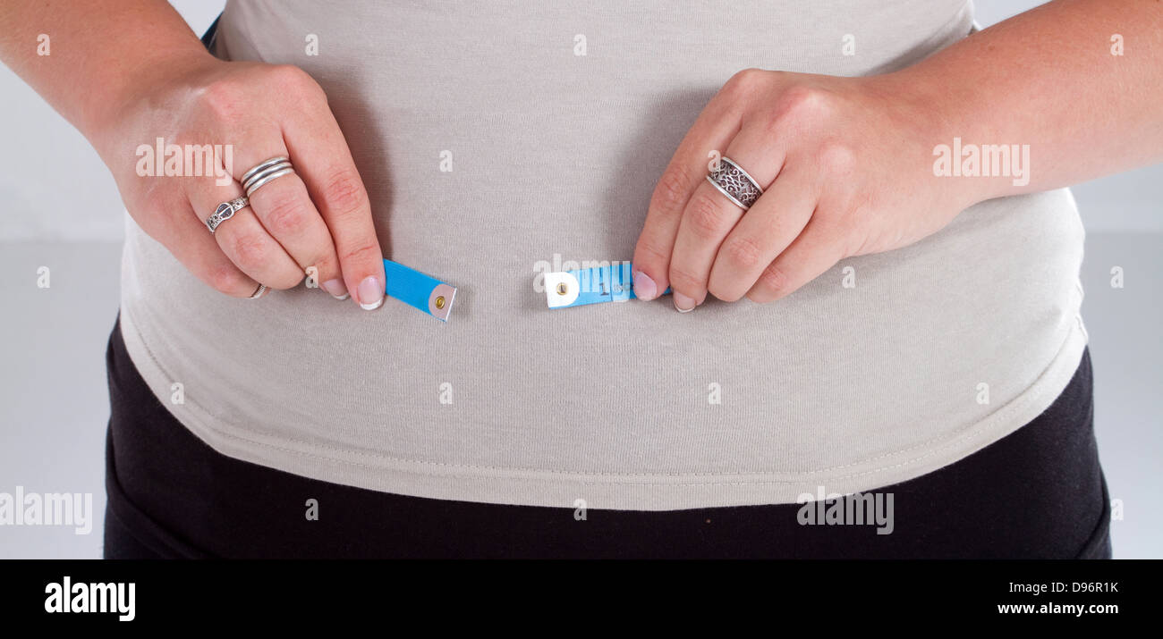 fat woman with measuring tape, the tape is not long enough Stock Photo
