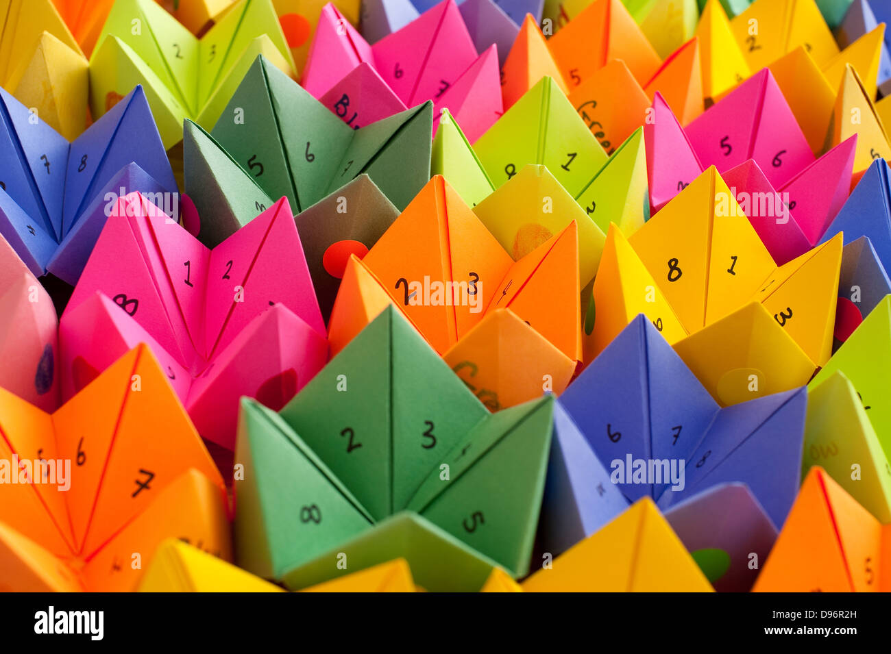 Multicolored cootie catchers, origami fortune teller with numbers and  positive words of encouragement game of chance Stock Photo - Alamy