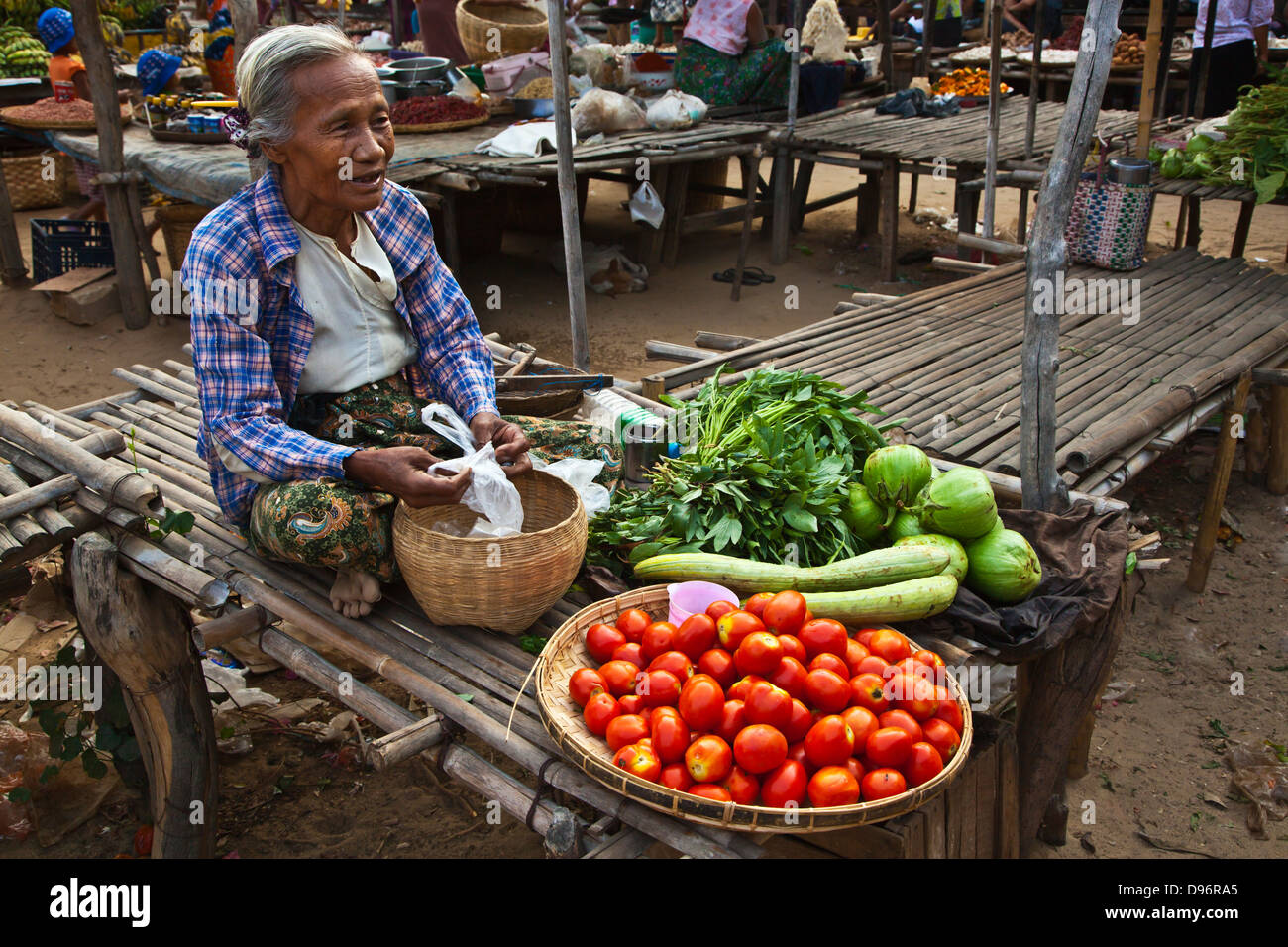 TOMATOES, EGGPLANT and ARMENIAN CUCUMBERS are offered for sale at the market in NEW BAGAN - BAGAN, MYANMAR Stock Photo
