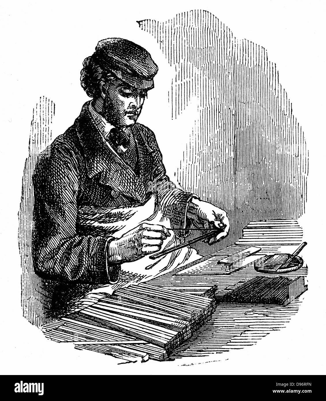 Setting lead (graphite) into grooved strip of cedar; a second strip of