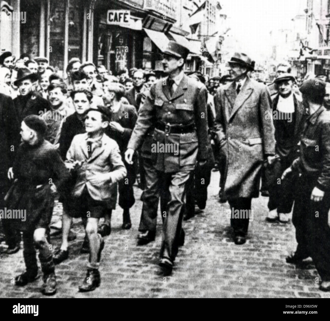 Charles de Gaulle (1890-1970) French General and first President of The Fifth Republic. De Gaulle walking through Bayeux, the first French town to be liberated, surrounded by rejoicing populace. On his left is Vienot, representative of the French provisional government in London. World War II: 14 June1944. Stock Photo