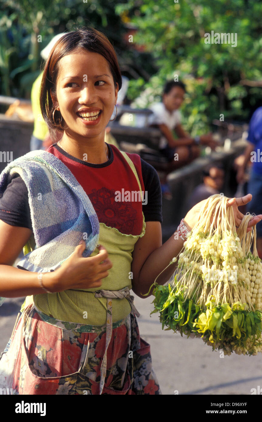 girl selling fragrant flowers outside tondo church manila philippines