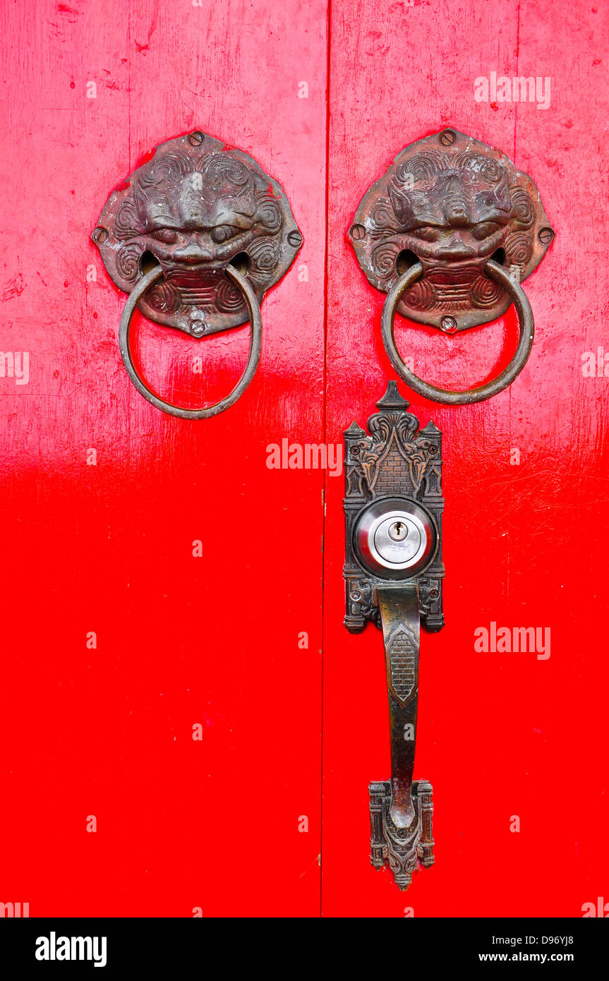 Red chinese door with a lion/dragon head. Stock Photo