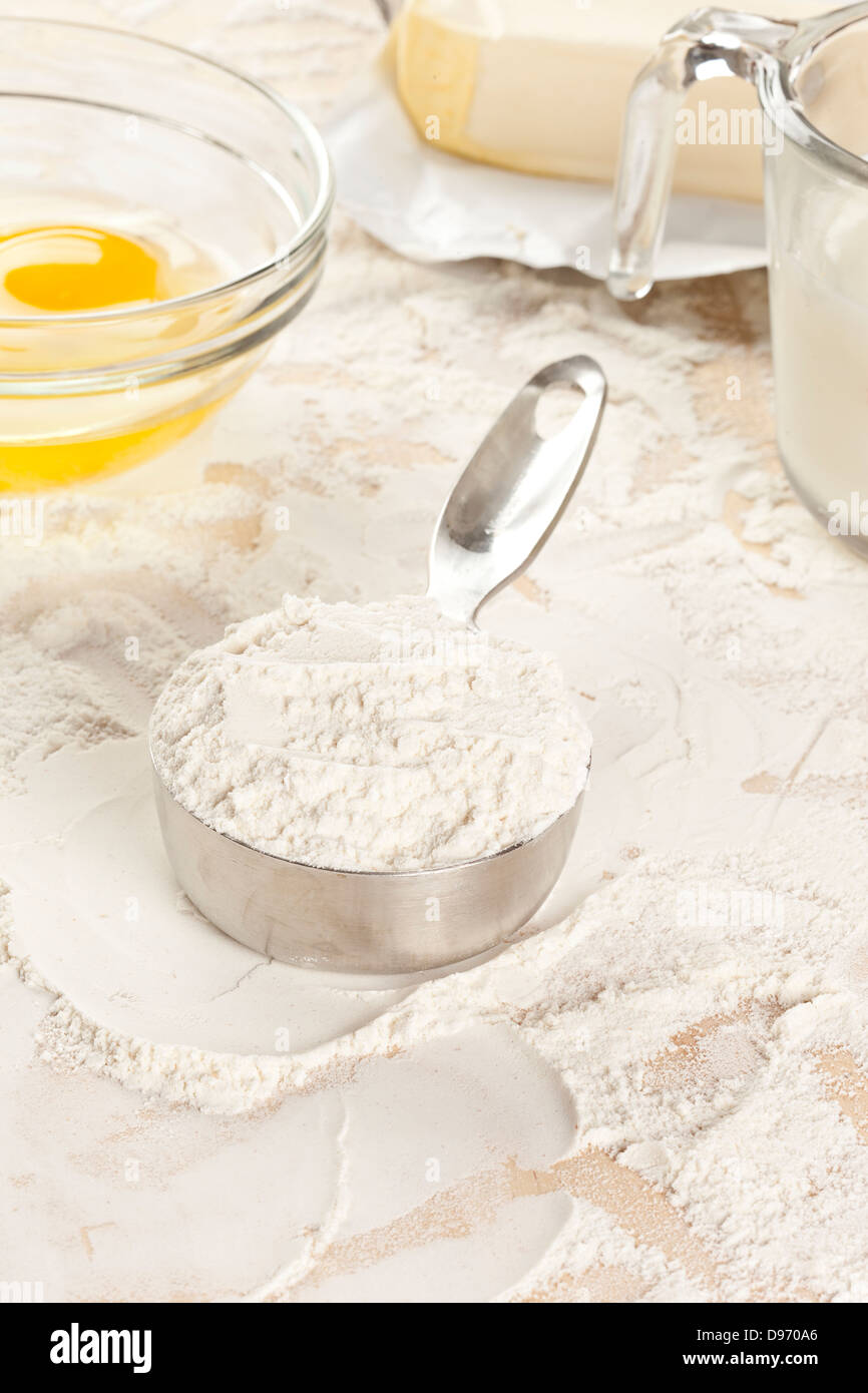 Whole grain white flour on a cutting board Stock Photo