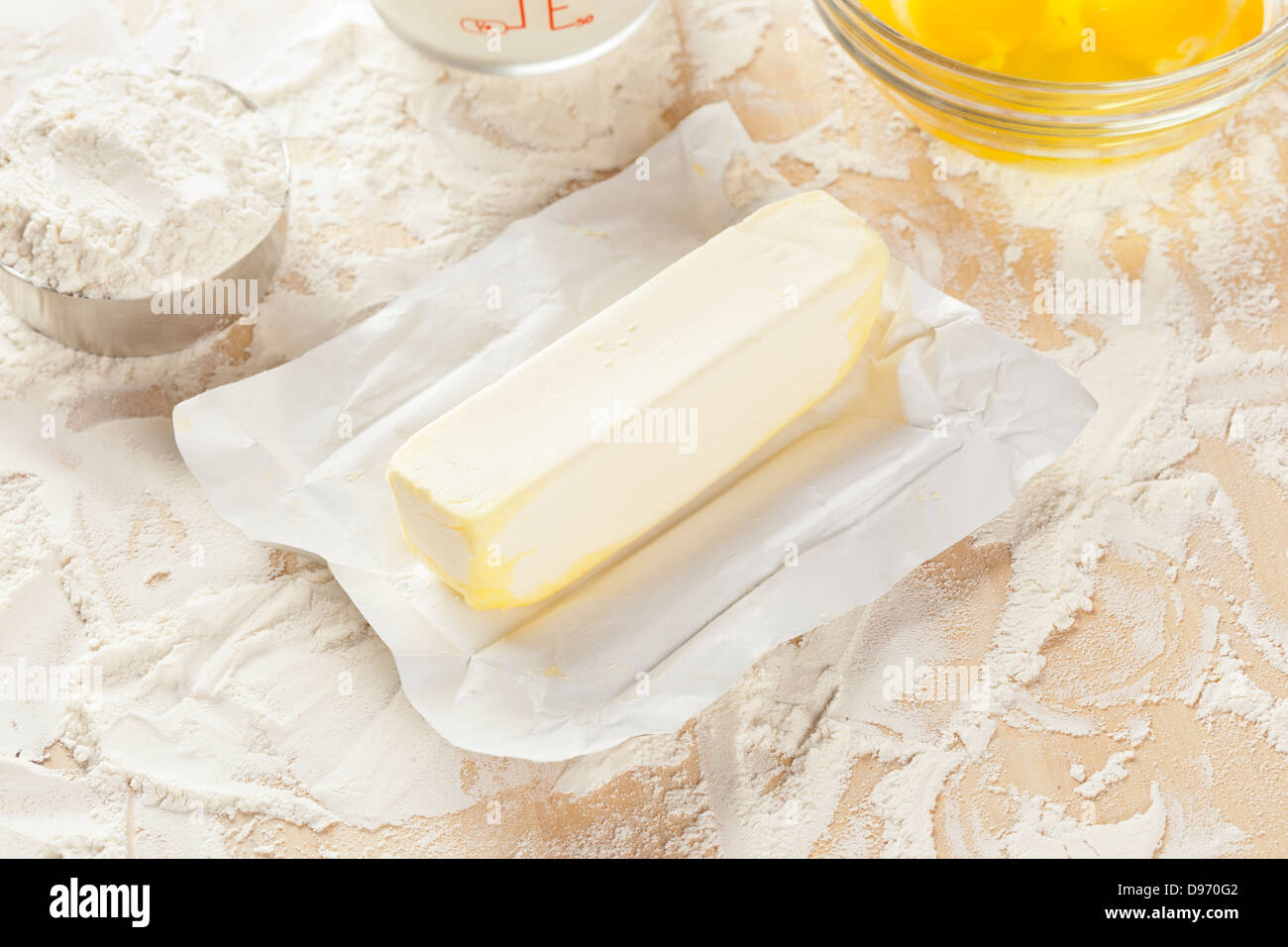 Fresh natural butter in front of baking ingredients Stock Photo