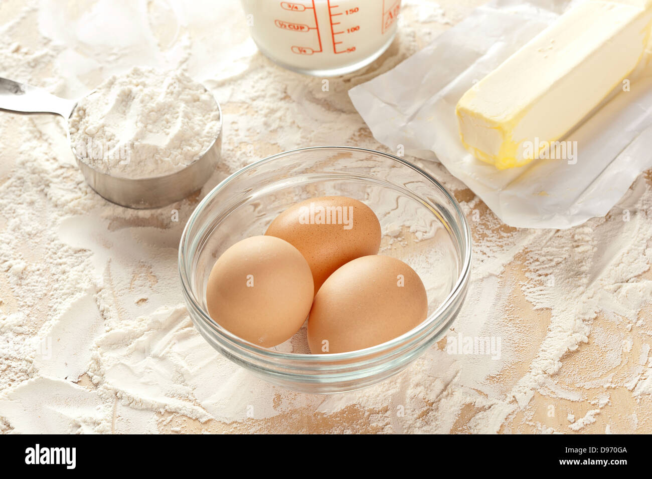 Baking ingredients including egg, flour, butter, and milk Stock Photo