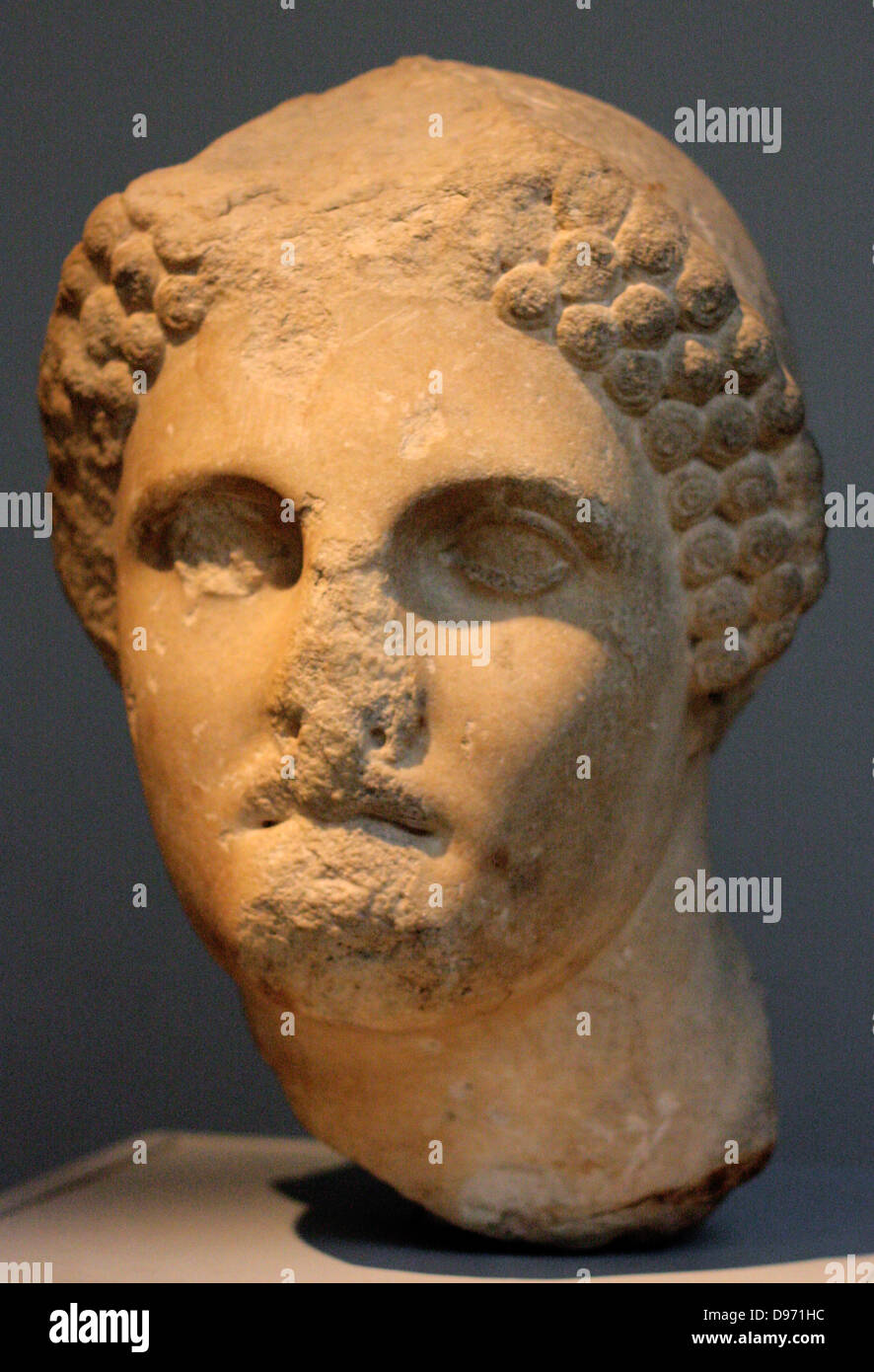 Head from a colossal statue of a woman wearing a sakko (cap) Parian marble found to the north west of the Mausoleum, about 350 BC The head comes from a statue of similar size to the colossal female figure displayed in this room (the-so-called Artemisia, Sculpture (100). This portrait may represent one of the female members of the Hekatomnid dynasty. The series of Dynastic portraits probably stood between the Ionic columns of the peristyle. Stock Photo