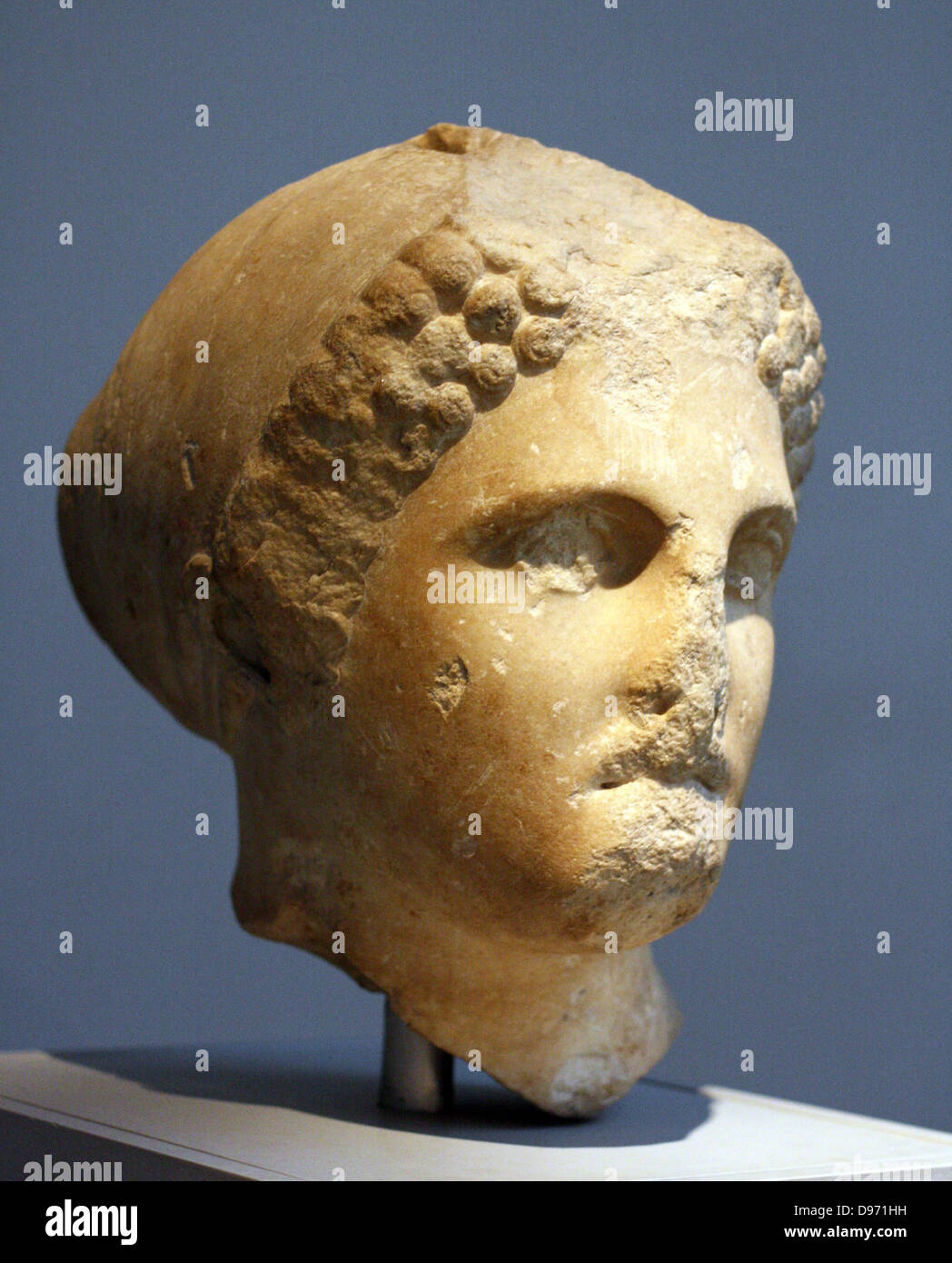 Head from a colossal statue of a woman wearing a sakko (cap) Parian marble found to the north west of the Mausoleum, about 350 BC The head comes from a statue of similar size to the colossal female figure displayed in this room (the-so-called Artemisia, Sculpture (100). This portrait may represent one of the female members of the Hekatomnid dynasty. The series of Dynastic portraits probably stood between the Ionic columns of the peristyle. Stock Photo