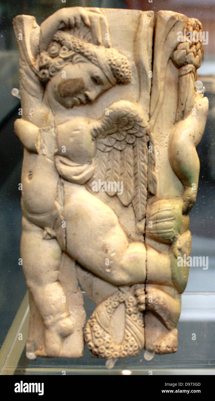 Fragmentary Ivory box decorated with a cupid and other companions of the wine-god Bacchus. Roman, 3rd century AD Stock Photo