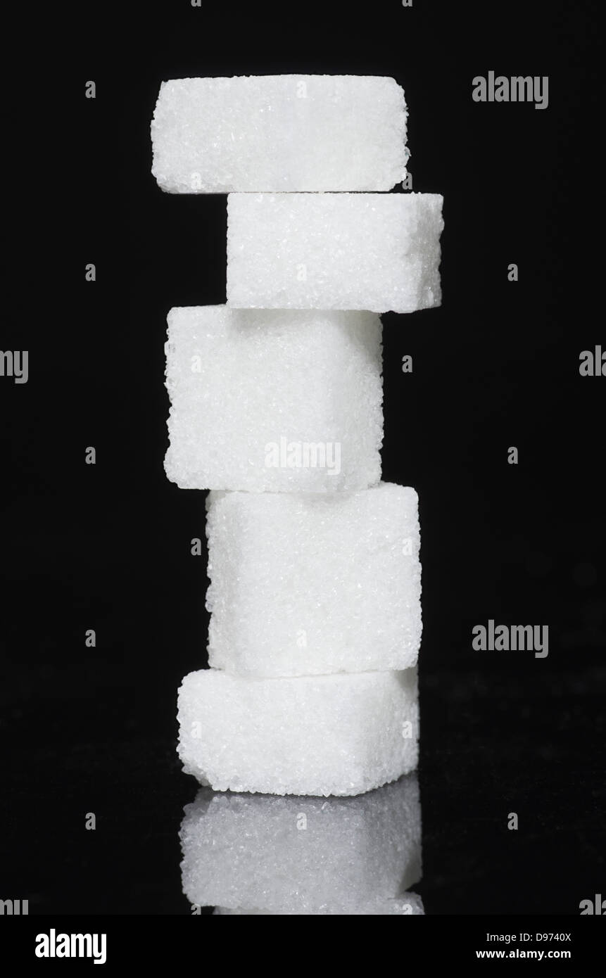 Stack of sugar cubes on black background Stock Photo - Alamy