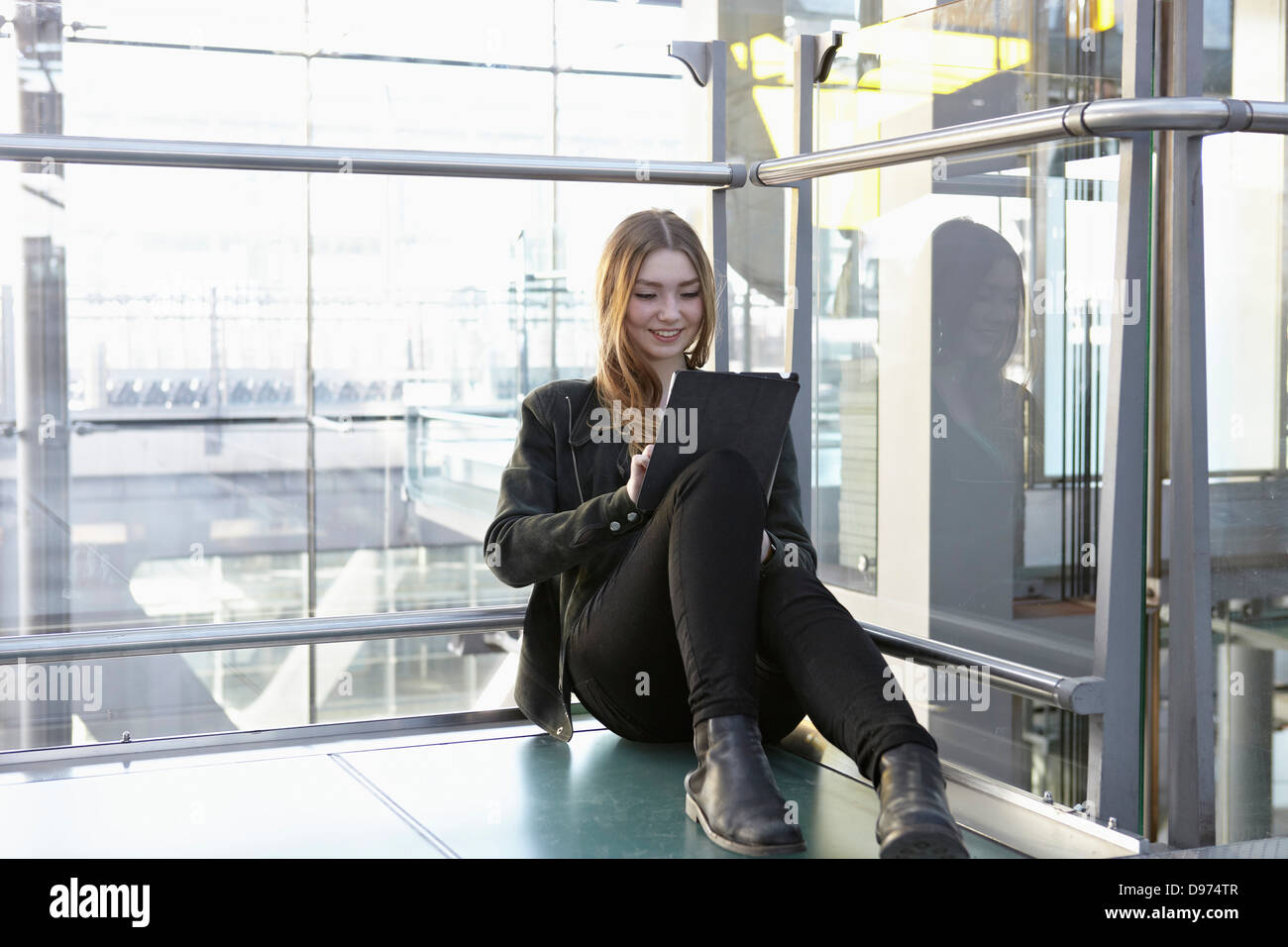 Germany, Cologne, Teenage girl using digital tablet Stock Photo