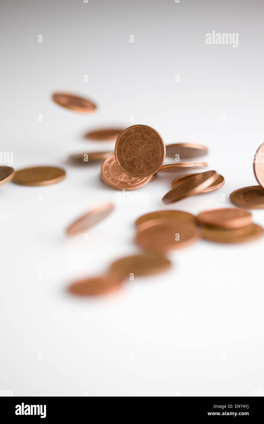 Euro coins falling on white background, close up Stock Photo - Alamy