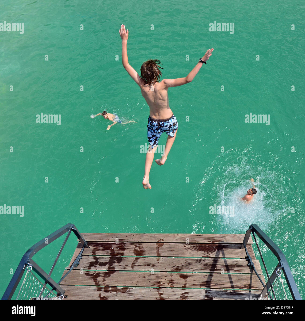 A boy jumps into the water at the Schwanseebad (Swan Lake Pool) in Weimar, Germany, 12 June 2013