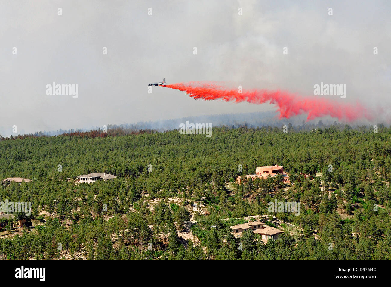 A DC-10 Air Tanker drops fire retardant to assist in fighting the Black Forest fire June 12, 2013 in El Paso County, CO. More than 100 homes have burnt in the fire south of Colorado Springs, CO. Stock Photo