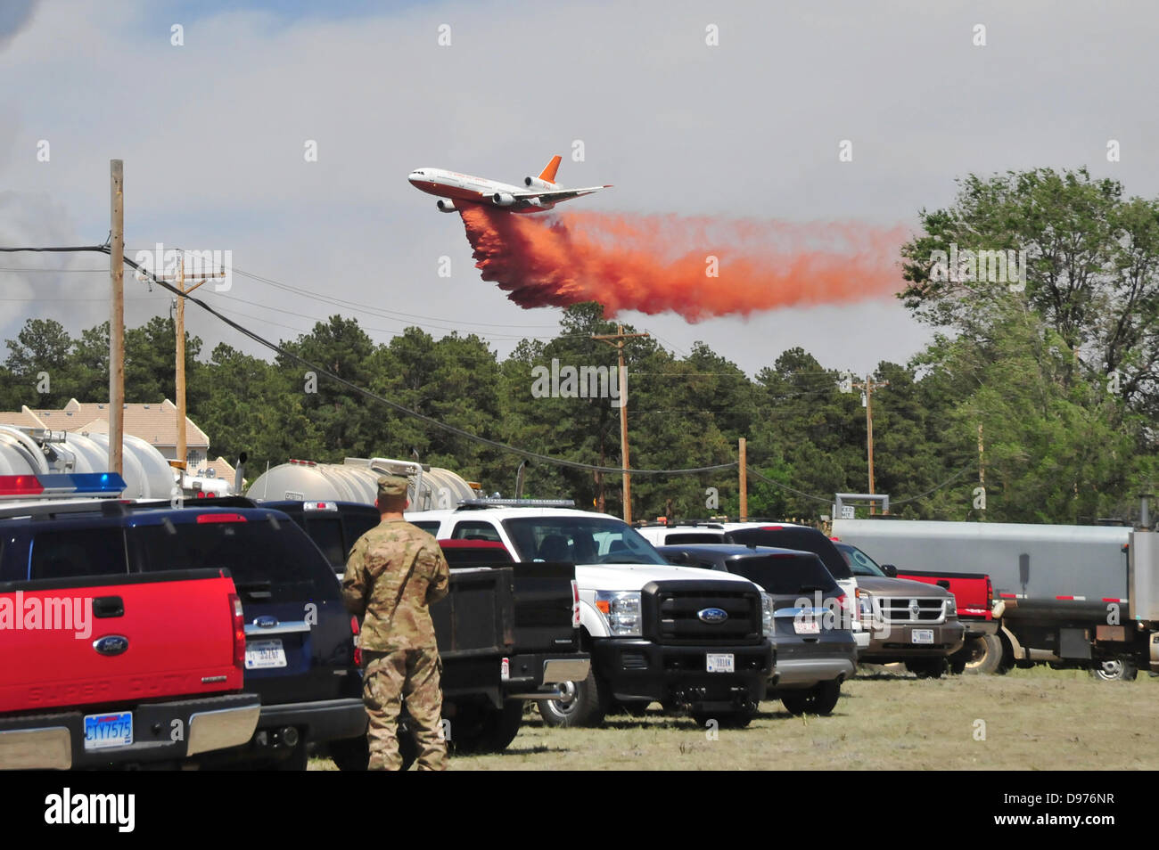 A DC-10 Air Tanker drops fire retardant to assist in fighting the Black Forest fire June 12, 2013 in El Paso County, CO. More than 100 homes have burnt in the fire south of Colorado Springs, CO. Stock Photo