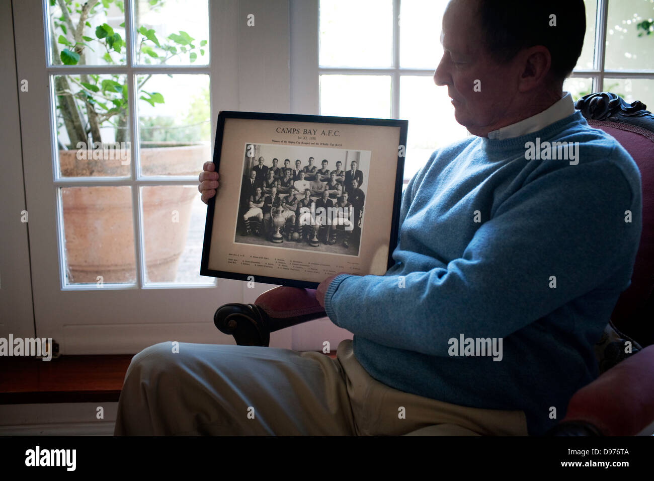 Eric Logan holds up photograph Camps Bay soccer club (where he was Captain)  in 1958 home in Newlands Cape Town South Africa He Stock Photo - Alamy