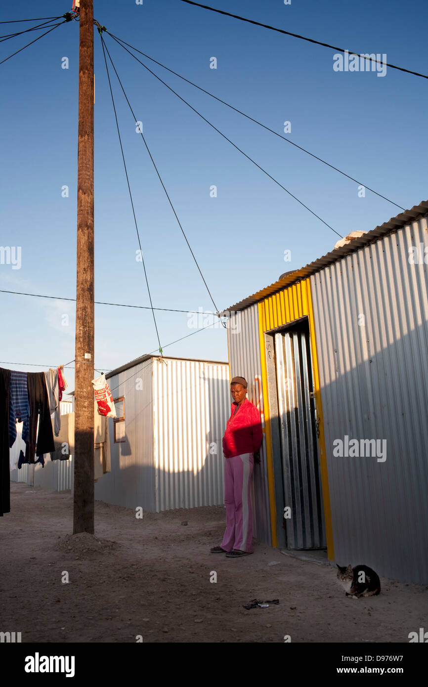 <p>Natasha stands outside her tin home. She was forcibly moved to Blikkiesdorp after living in Seapoint for 15 years.</p> Stock Photo
