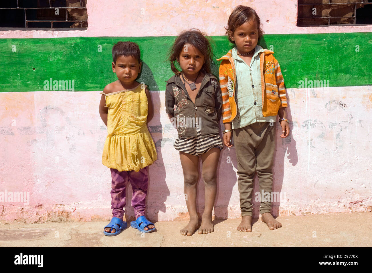 indian kids line up to show healthy height for their age indicated by the top of the green line Stock Photo