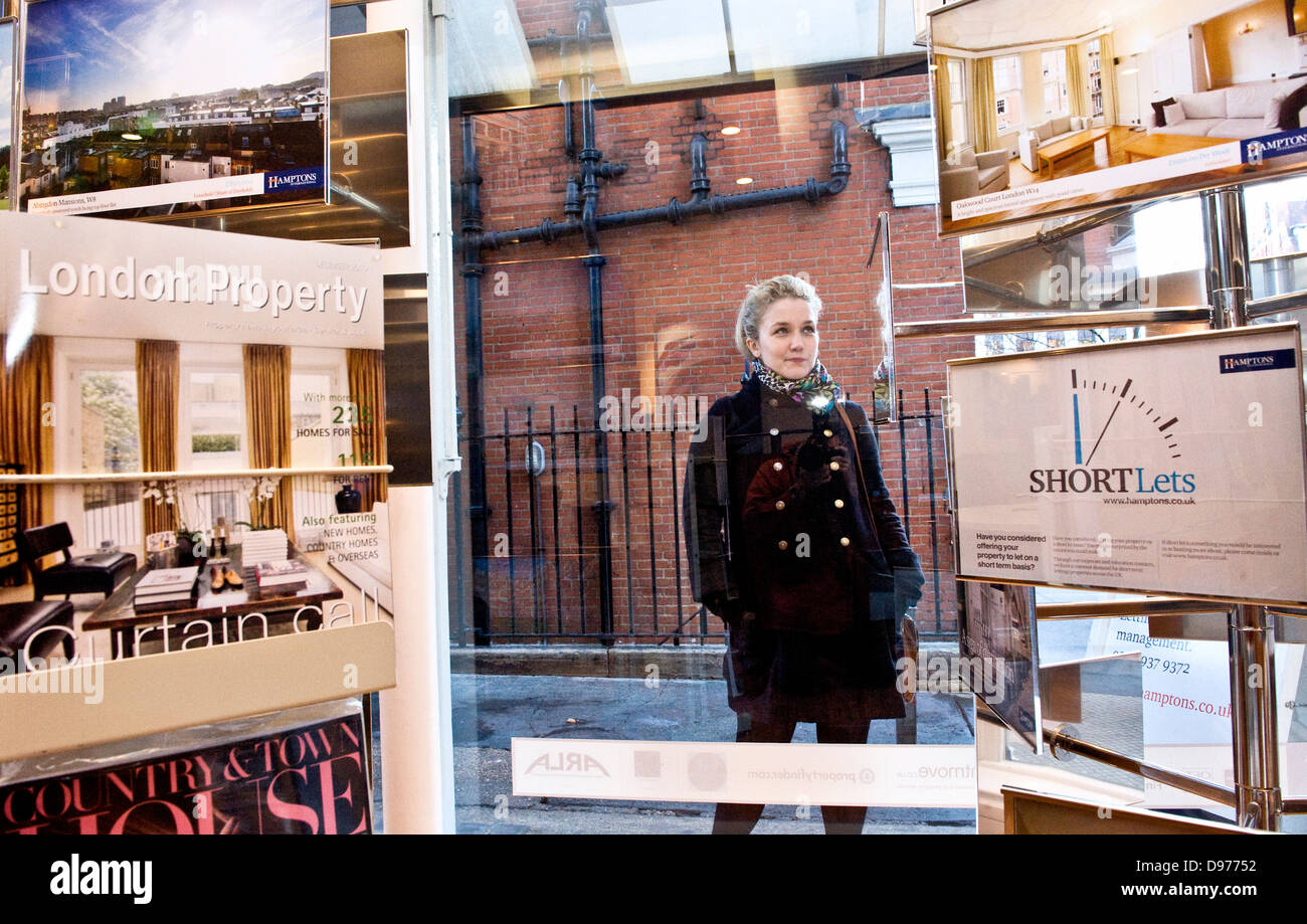 girl surveys lettings High St Kensington branch of Hamptons Estate