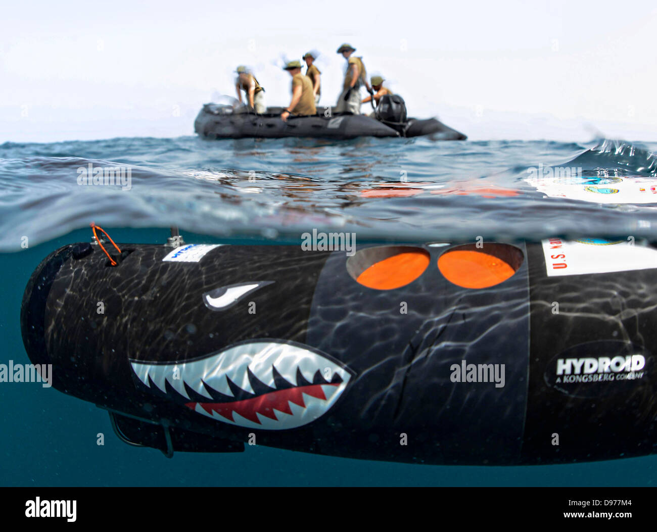 US Navy sailors with the Naval Oceanography Mine Warfare Center deploy an unmanned underwater vehicle to search for mines as part of a training exercise May 18, 2013 in the Arabian Sea. Stock Photo