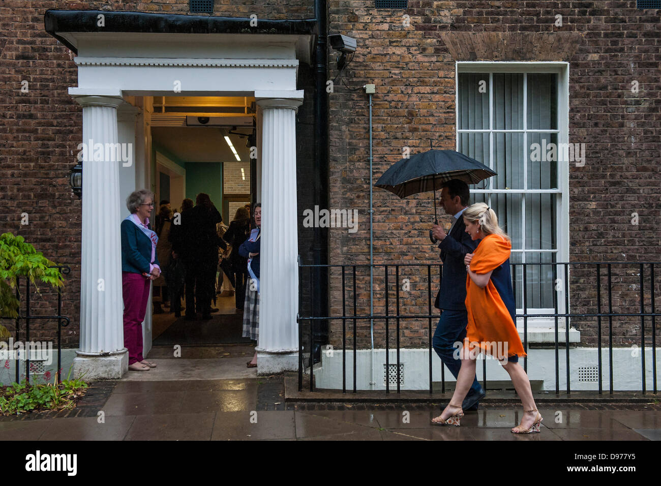Clapham, London, UK. 12 June 2013.Heavy rain fails to dampen the spirits at the Wandsworth Friends of Trinity Hospice Summer Party. Clapham, London, 12 June 2013. Credit:  Guy Bell/Alamy Live News Stock Photo
