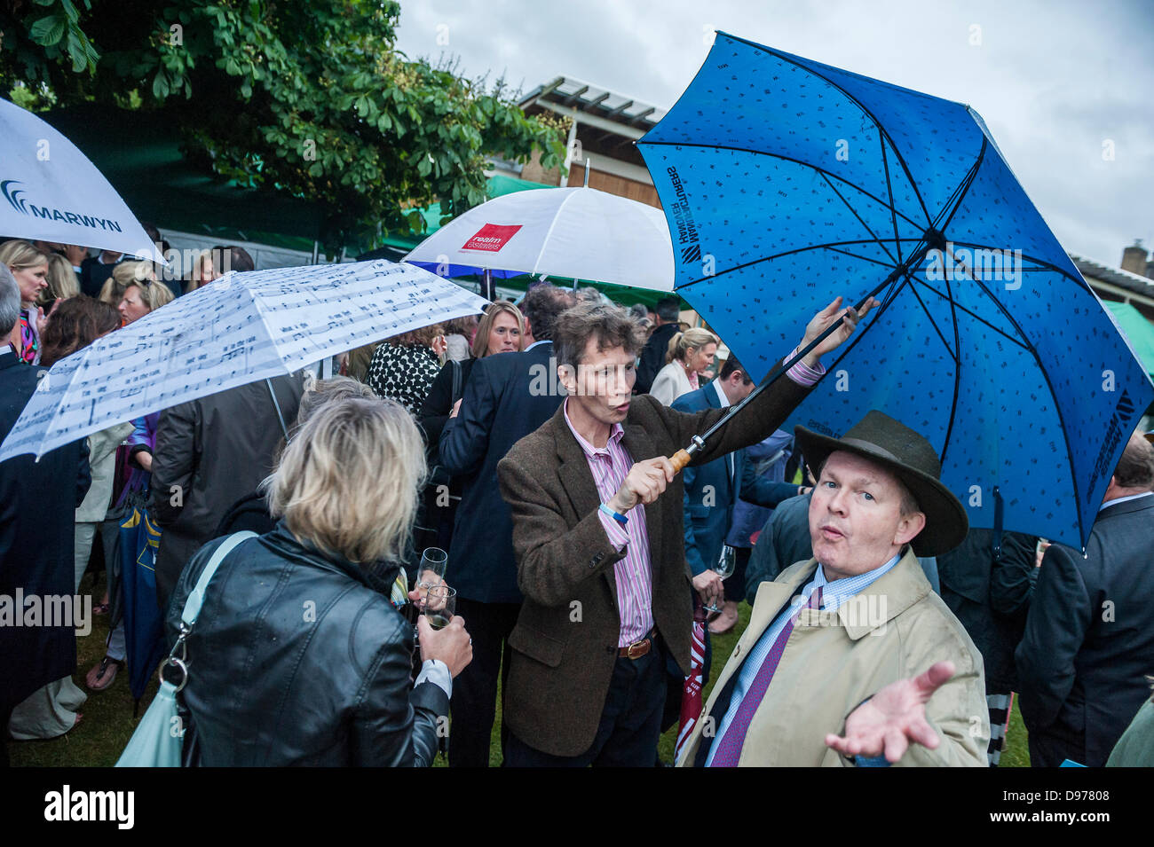 Clapham, London, UK. 12 June 2013.Heavy rain fails to dampen the spirits at the Wandsworth Friends of Trinity Hospice Summer Party. Clapham, London, 12 June 2013. Credit:  Guy Bell/Alamy Live News Stock Photo