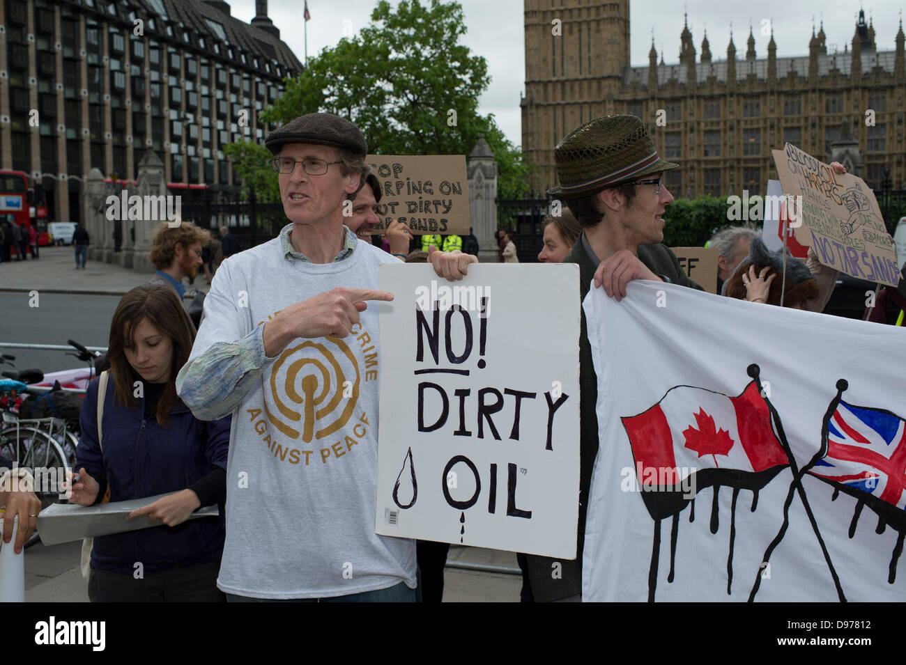 Westminster, London, UK. 13th June 2013. Parliament Square, London. A small but passionate groups of protesters await the arrival of Canadian Prime Minister, Stephen Harper. Harper is addressing both Houses of Parliament. He is lobbying against an EU climate legislation keeping tar sands out of Europe due to the impact it will have on Climate. The anti-tar sands lobby has the backing of 25 trans-Atlantic groups including Greenpeace and Council of Canadians. Credit:  Allsorts Stock Photo/Alamy Live News Stock Photo