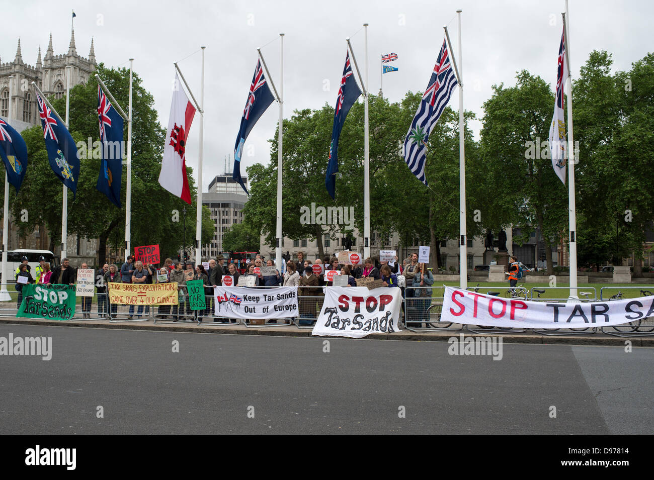 Westminster, London, UK. 13th June 2013. Parliament Square, London. A small but passionate groups of protesters await the arrival of Canadian Prime Minister, Stephen Harper. Harper is addressing both Houses of Parliament. He is lobbying against an EU climate legislation keeping tar sands out of Europe due to the impact it will have on Climate. The anti-tar sands lobby has the backing of 25 trans-Atlantic groups including Greenpeace and Council of Canadians. Credit:  Allsorts Stock Photo/Alamy Live News Stock Photo