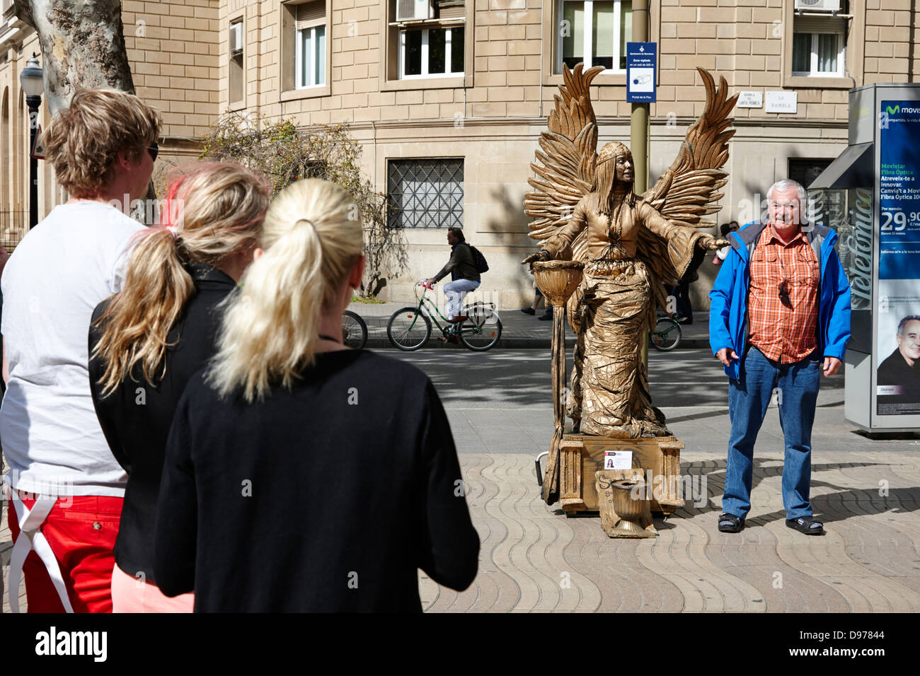 tourists with living statue street performer on la rambla barcelona catalonia spain Stock Photo