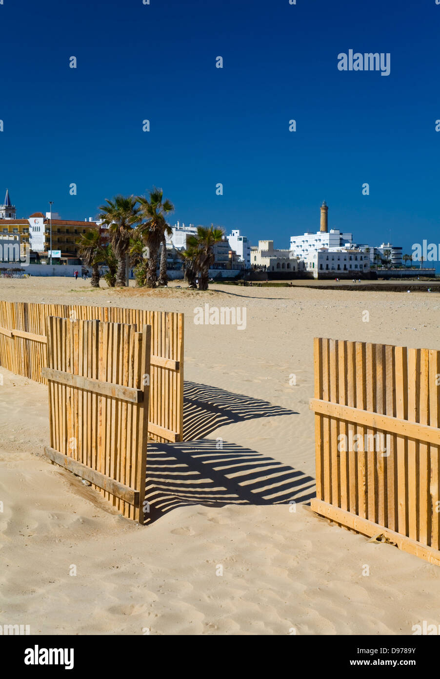beach and wooden fence and village. Chipiona, Cadiz, Andalusia, Spain Stock Photo