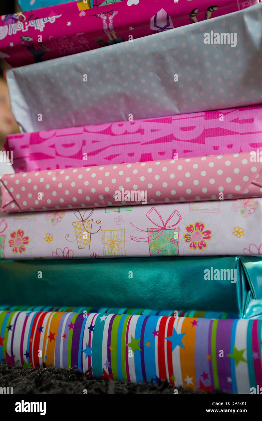 A pile of wrapped girls birthday presents Stock Photo