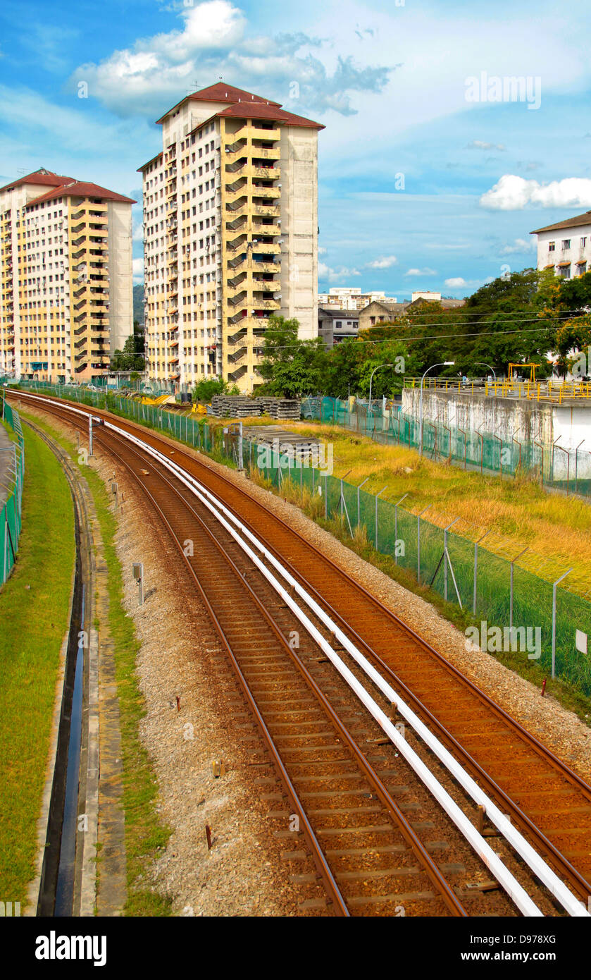 Railway track passing through housing area. Concept of urban transportation and noise pollution. Stock Photo