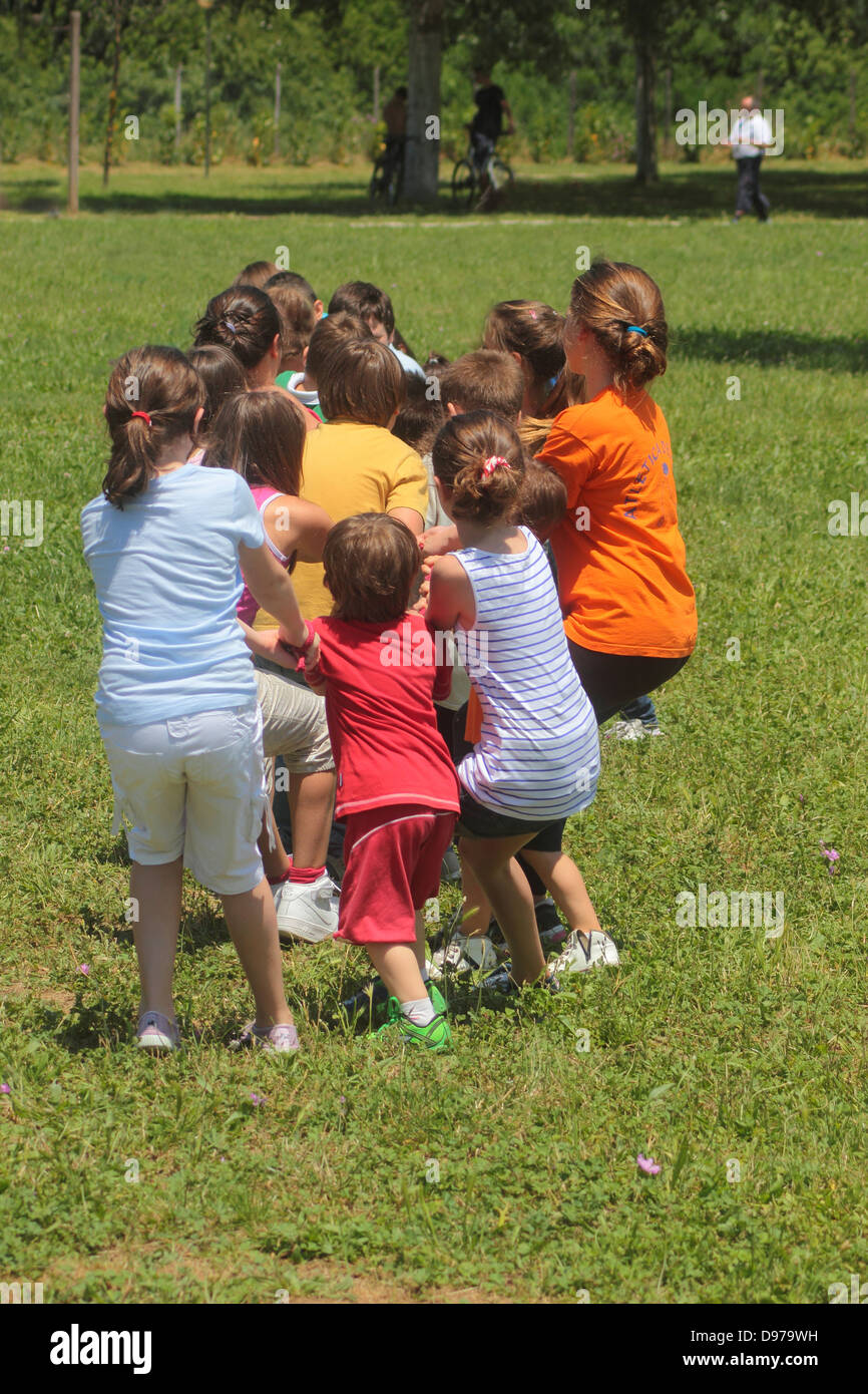 Crowd of children (5-10 yrs old) playing with a rope Stock Photo