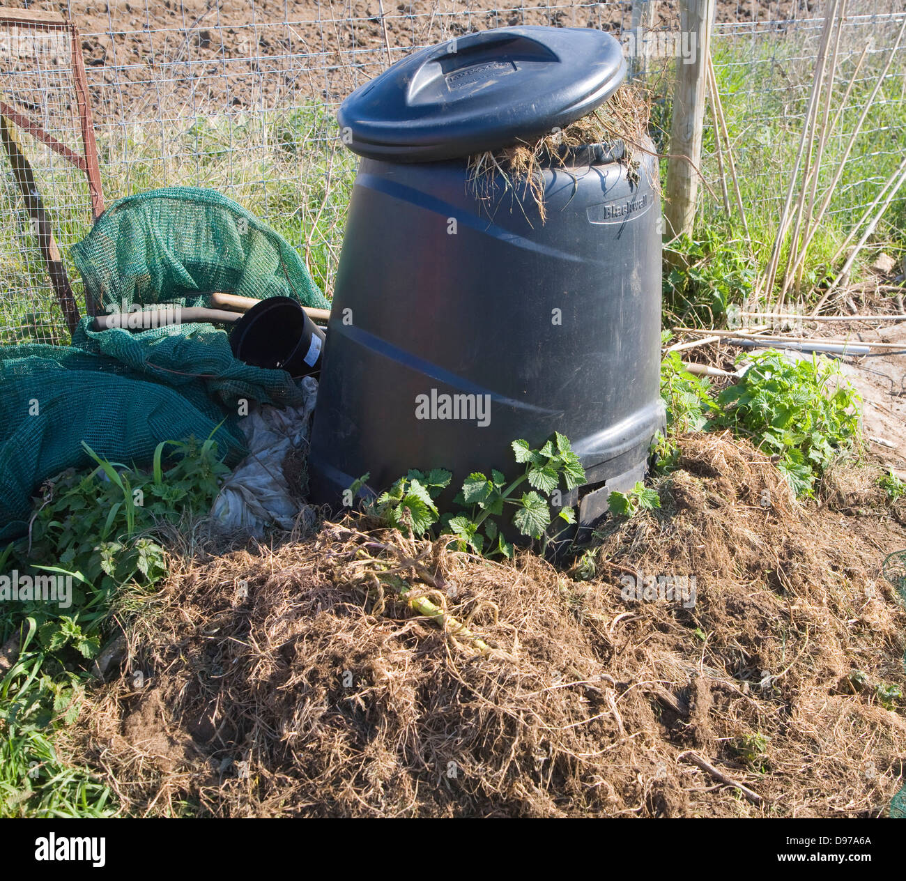 Compost bin decomposing plants in allotment garden, UK Stock Photo