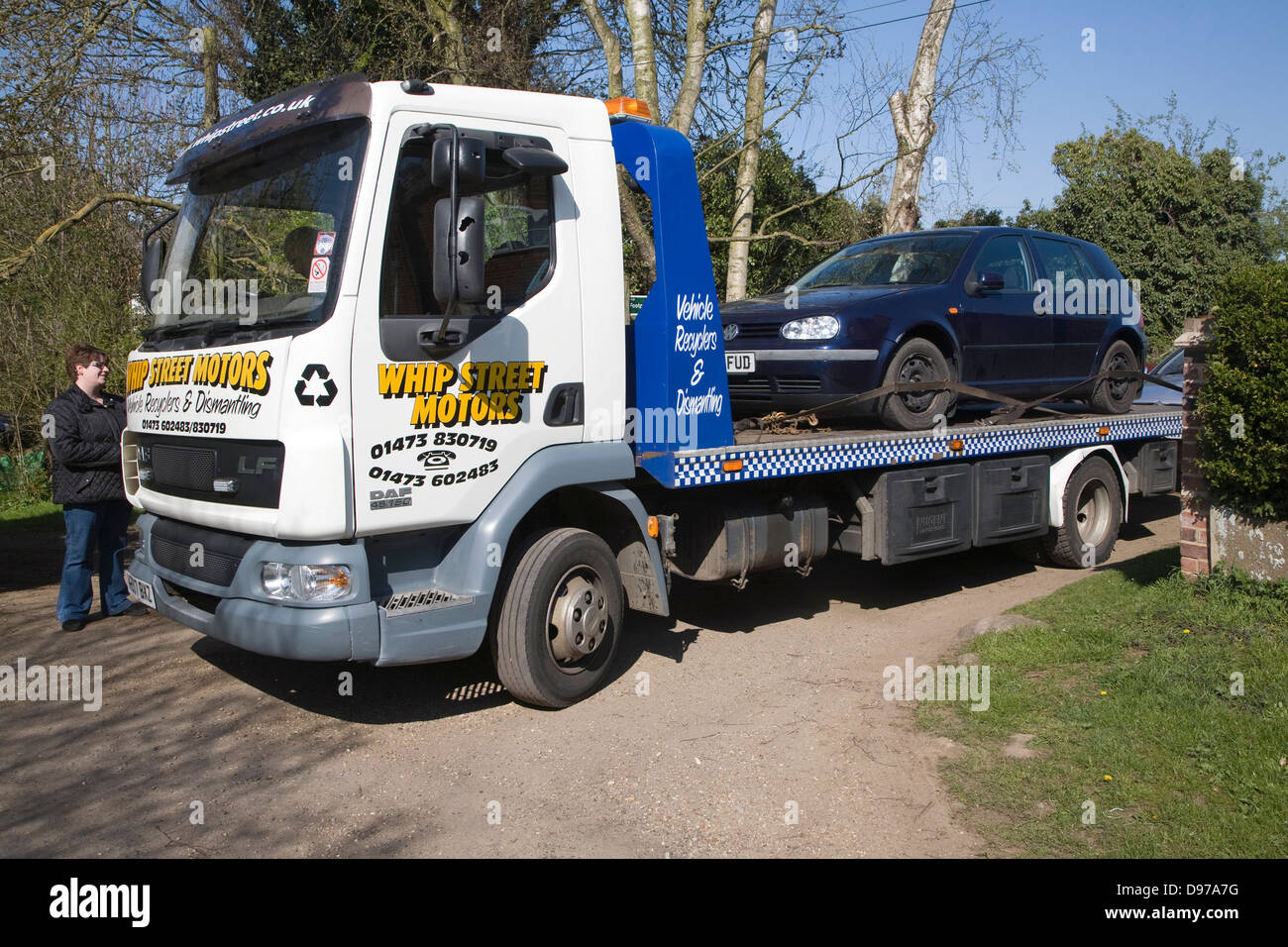Old car being taken away to be scrapped on the back of truck, Suffolk, England Stock Photo