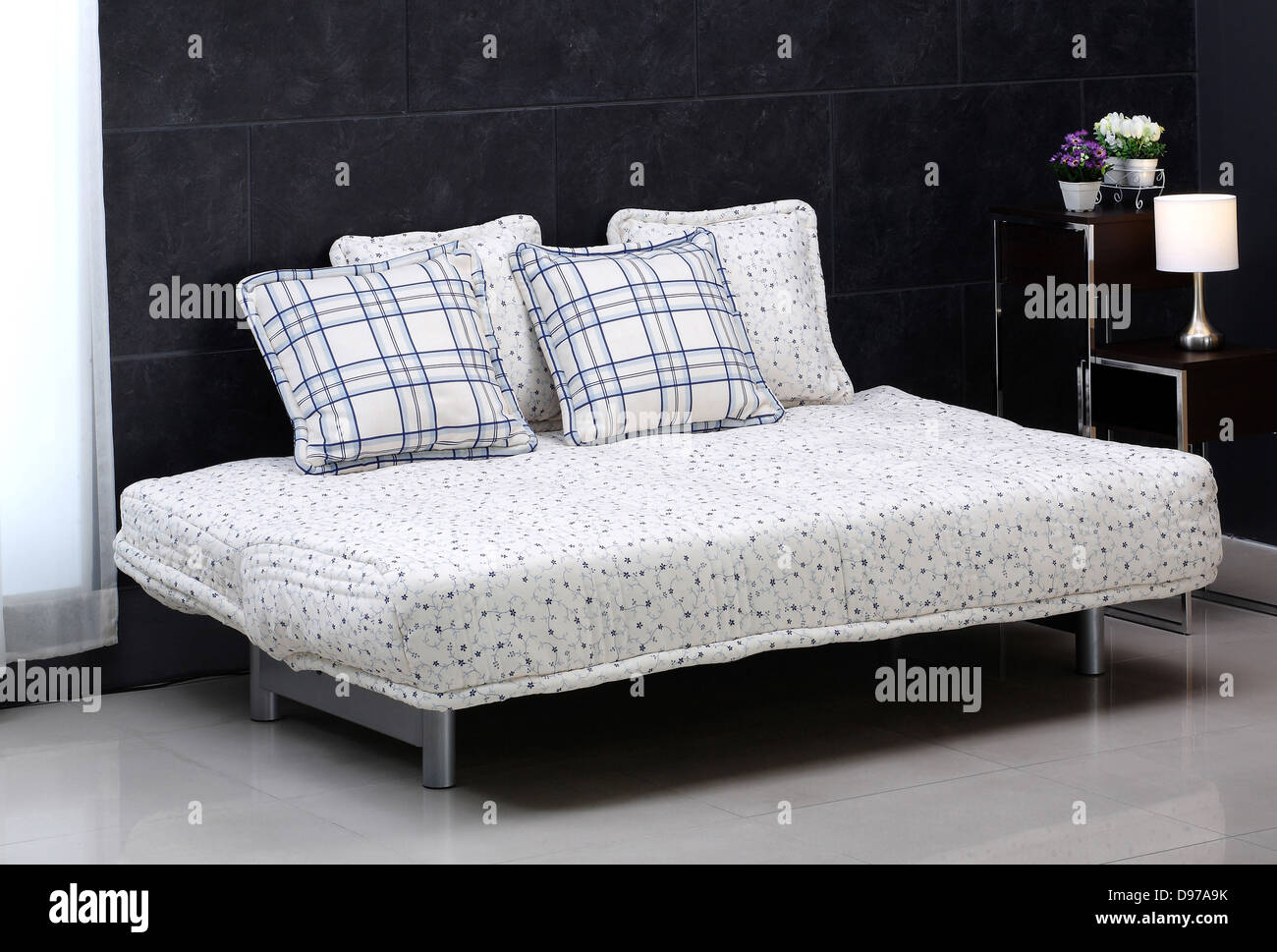 A lovely comfortable sofa bed and cute cushions Stock Photo