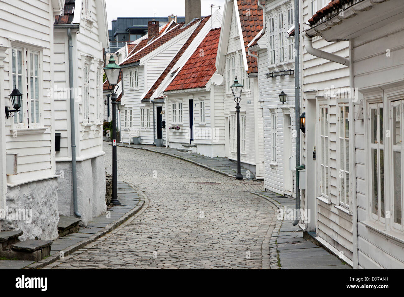 White Clapboard houses straddle Ovre Strandgate in Old Stavanger Norway Stock Photo
