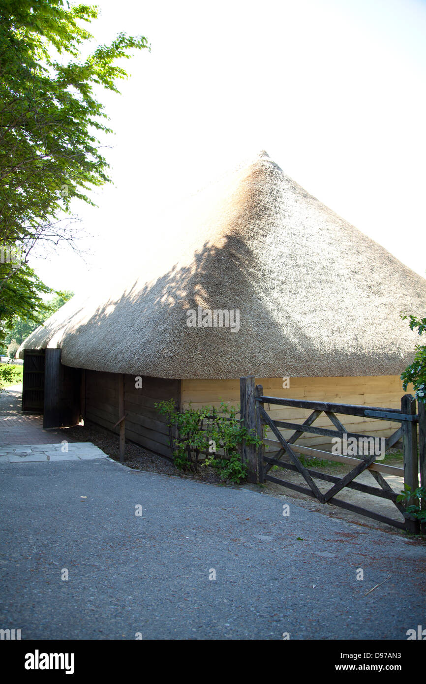 Aisled thatched 18th century timber framed barn (originally from Hambrook, Sussex) on a summer's day - as seen on BBC The Repair Shop Stock Photo