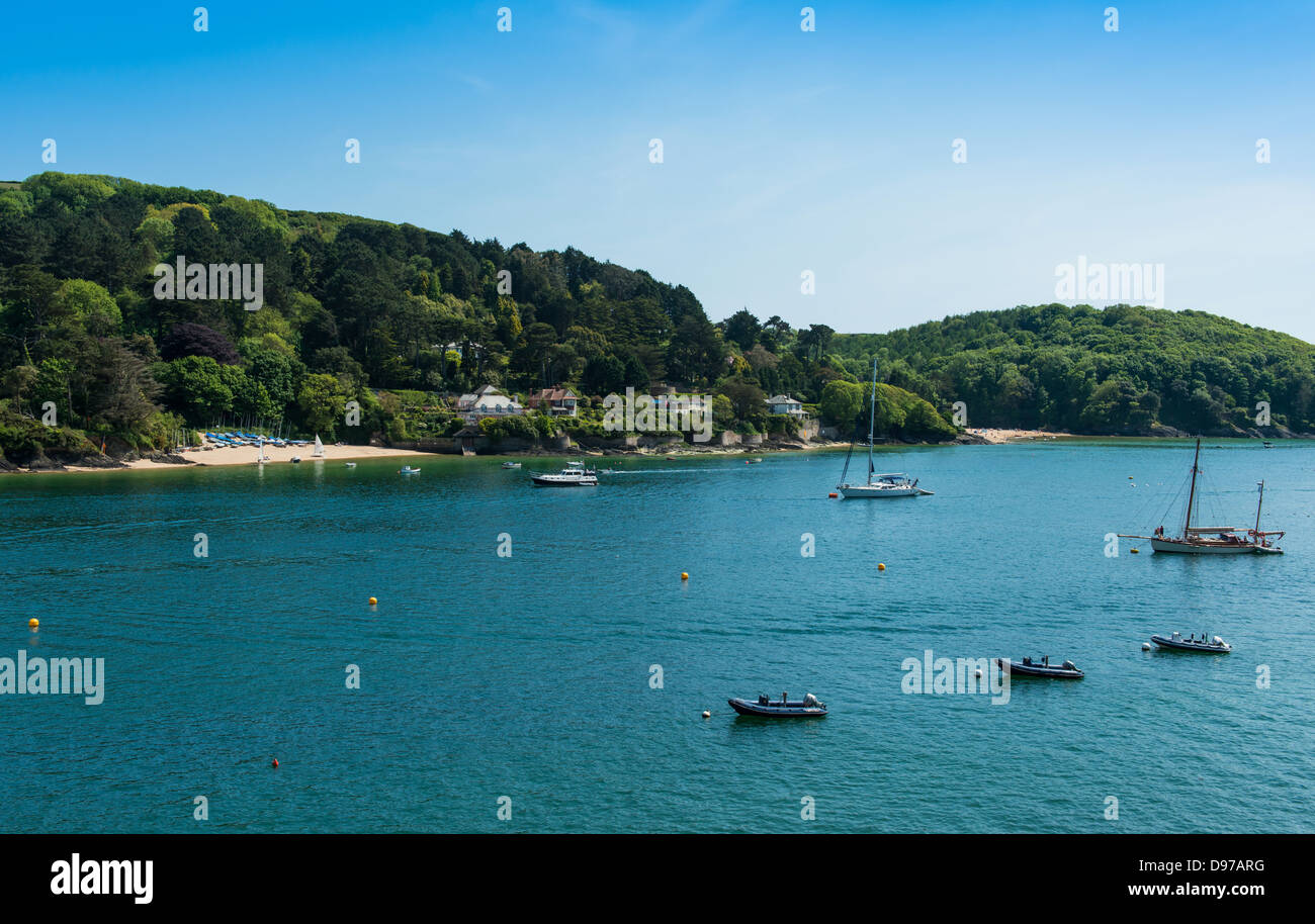 Salcombe and East Portlemouth, Devon. June 3rd 2013.  Sunny Cove beach with moored yachts and dingies. Stock Photo
