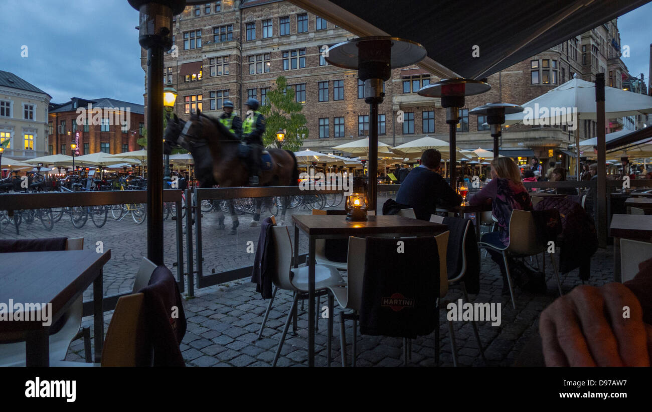 Mounted police patrol the restaurant district Lilla Torg in Malmö Sweden Stock Photo