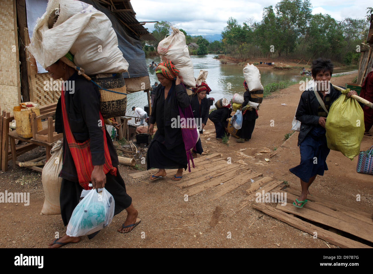 coming from Nam Pan market with food produce  to be stored in their homes Stock Photo