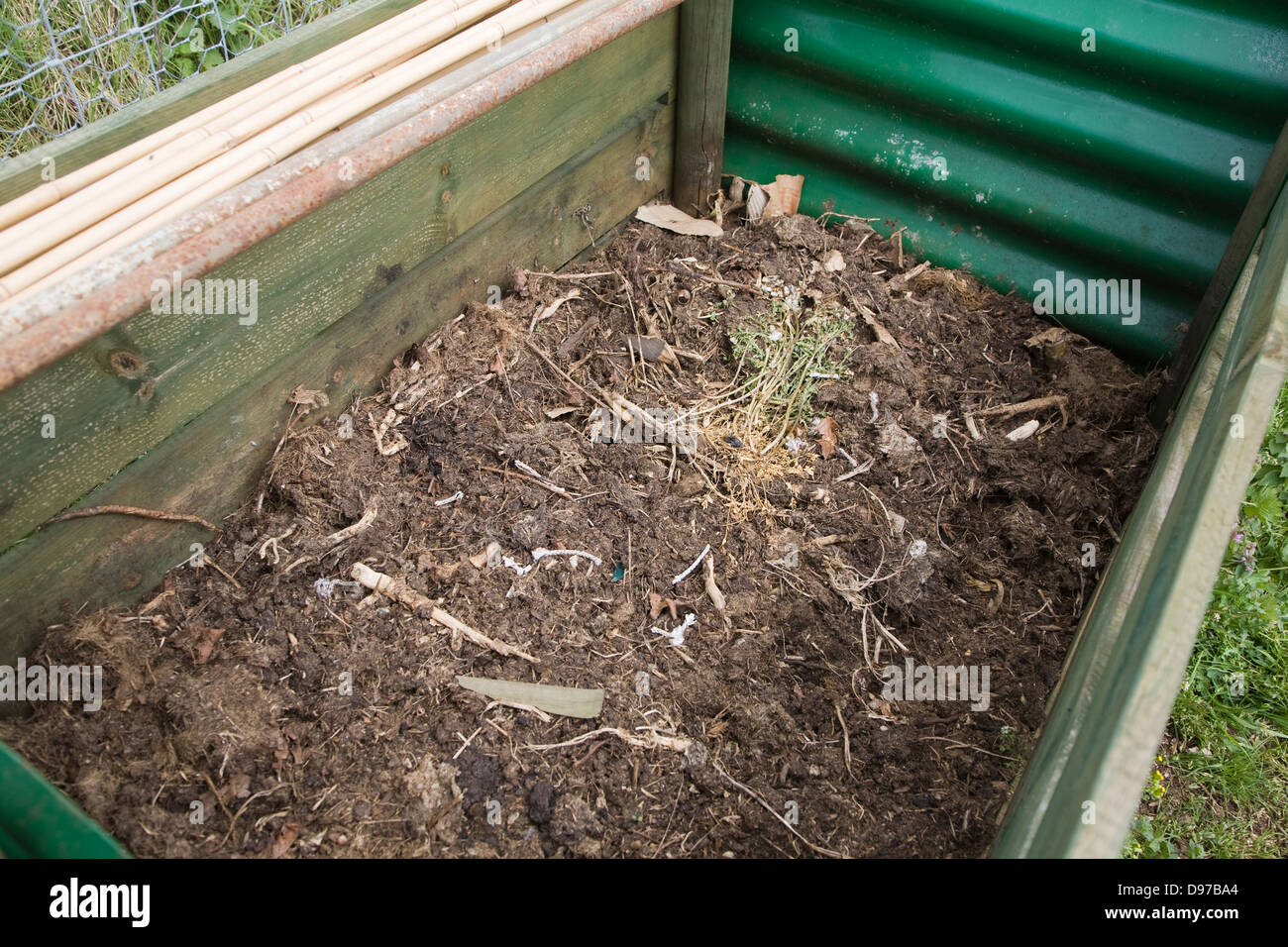 Rotted compost in garden composting bin Stock Photo