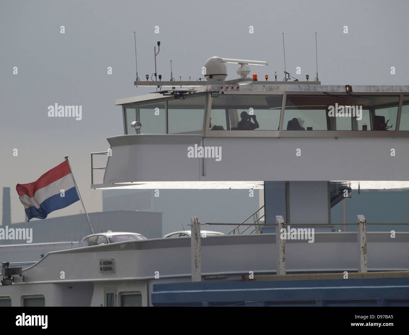 Captain on the bridge of a Dutch cargo barge ship in the port of Rotterdam, the Netherlands Stock Photo