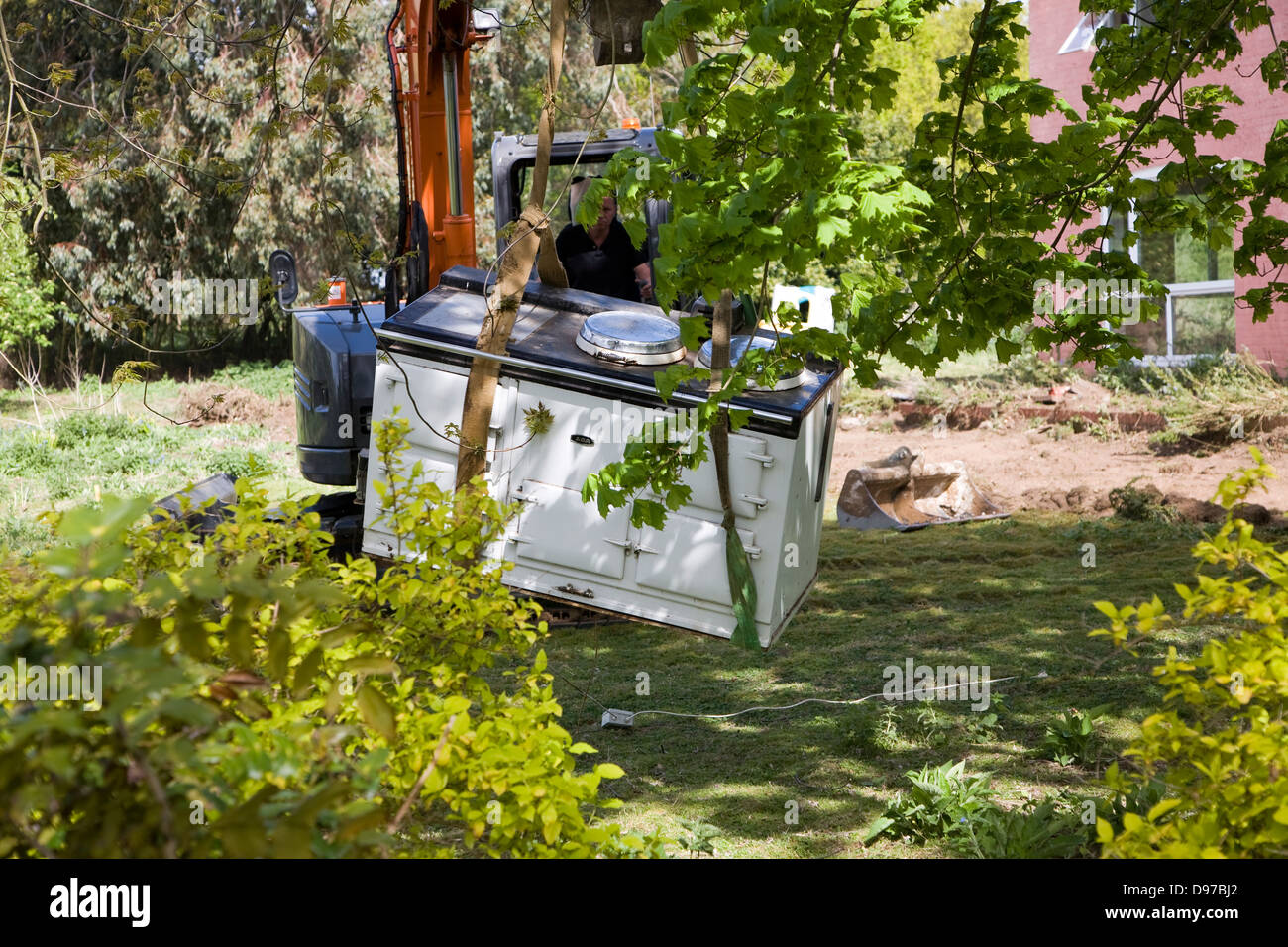 Crane removing Aga cooker from house about to be demolished, Shottisham