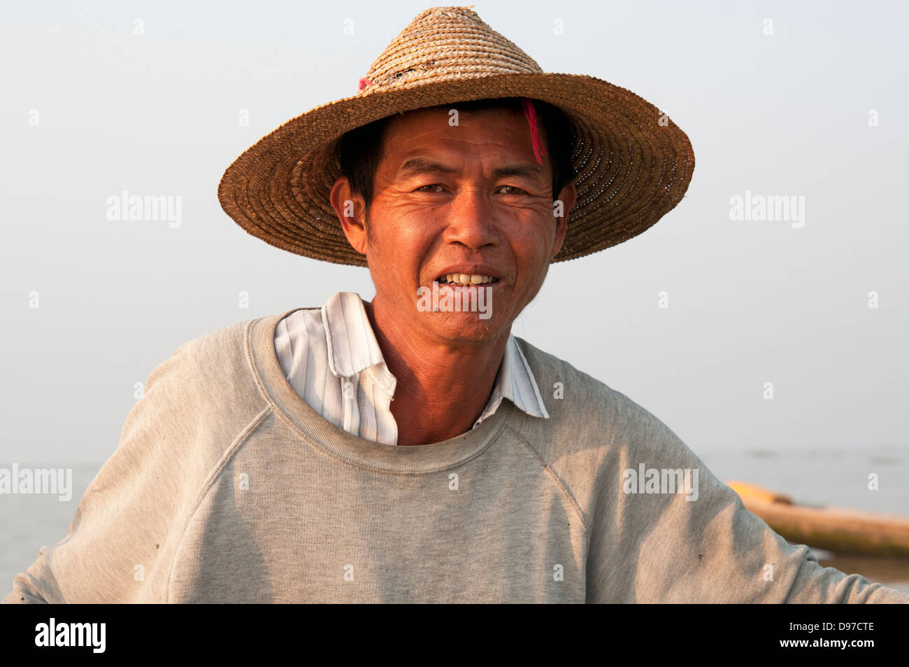 Portrait of a Intha fisherman wearing a straw hat on Inle lake