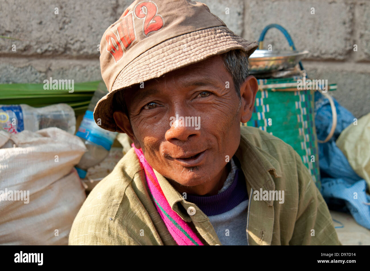 Man wearing hat smiling at the camera in a market Myanmar (Burma) Stock Photo