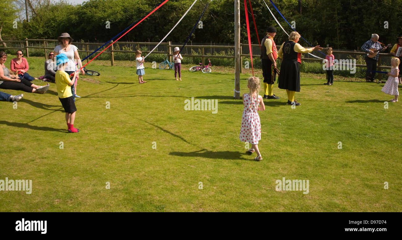 Children dance around a maypole at an English country festival